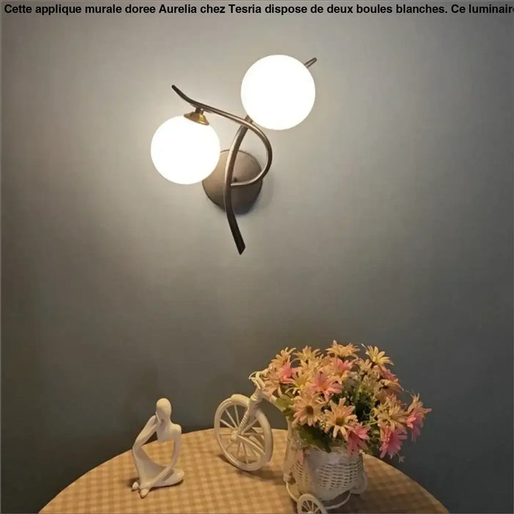 Modern applique murale doree Aurelia with curved metallic arms and frosted white spherical bulbs