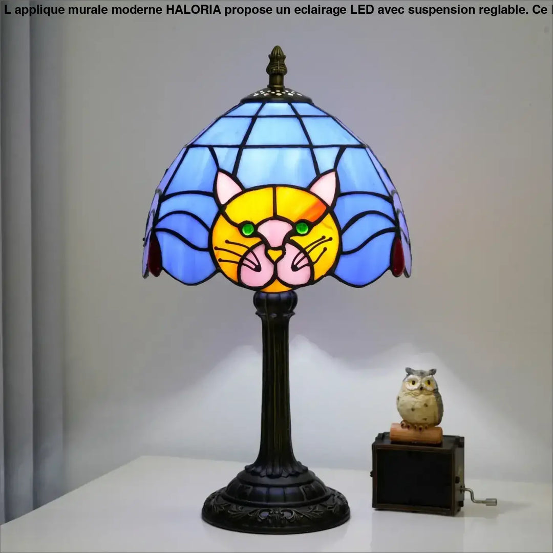 Lampe de chevet miaou en verre teinté bleu et jaune avec visage de chat vert et base en métal orné sombre