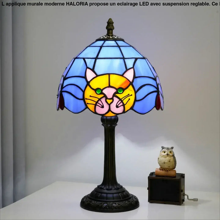 Lampe de chevet miaou en verre teinté bleu et jaune avec visage de chat vert et base en métal orné sombre