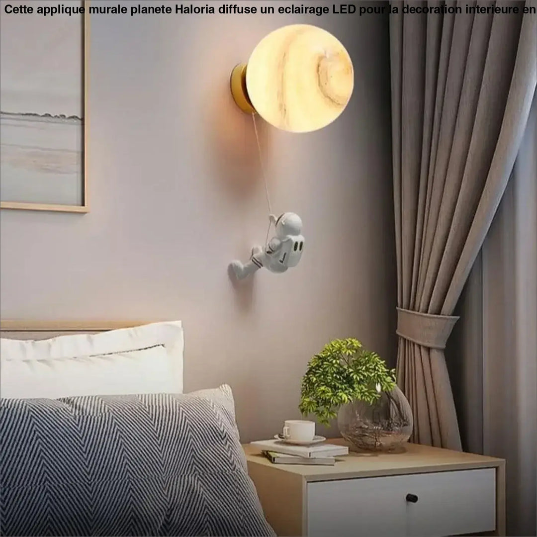 Applique murale planete haloria ronde ton chaud avec finition effet marbre et figurine astronaute suspendue
