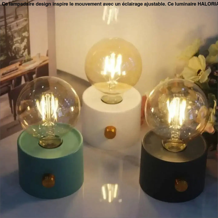 Veilleuse moderne monora avec ampoule apparente dans trois couleurs teal, blanc et noir sur socle cylindrique
