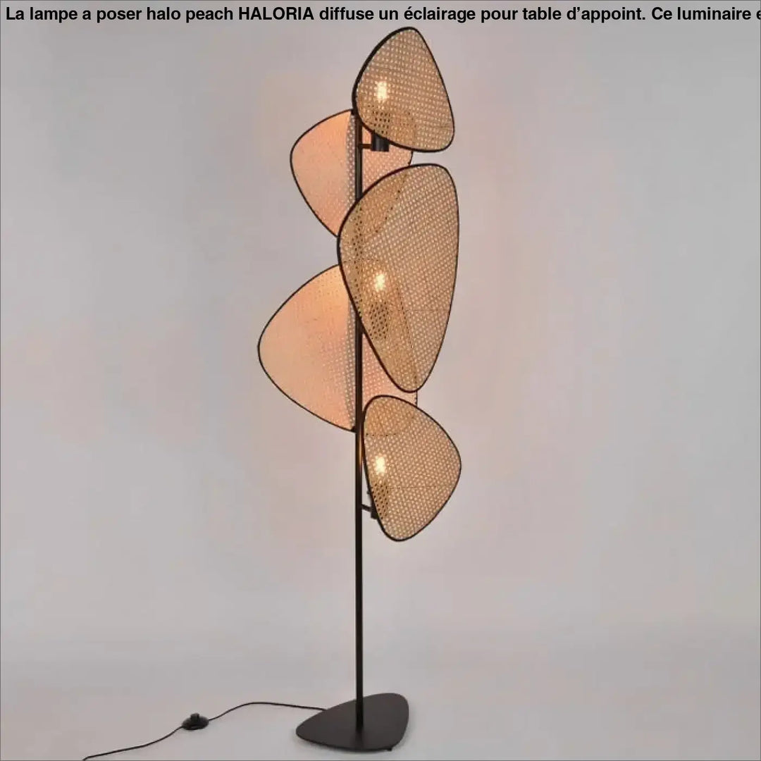Lampadaire poser halo peach avec cinq abat-jours superposés en matériaux naturels tressés beige chaud et structure métal noir