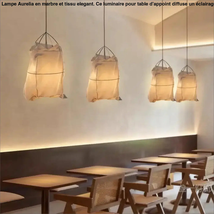 Suspension luminaire lima avec quatre lanternes en tissu beige diffuses et cadre métal noir style scandinave