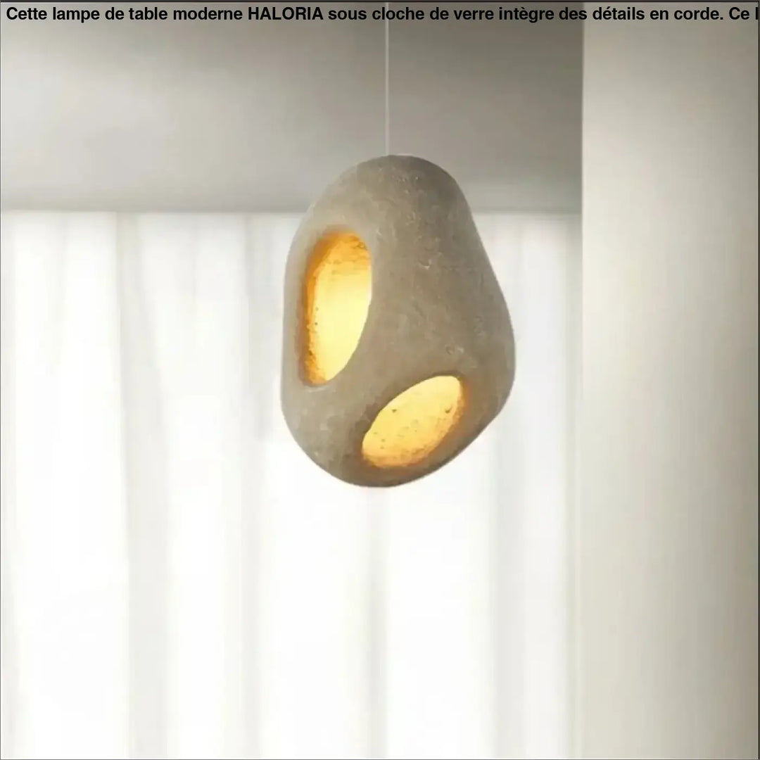 Suspension luminaire cavia en béton moderne avec surface texturée grise et deux ouvertures circulaires à ton chaud