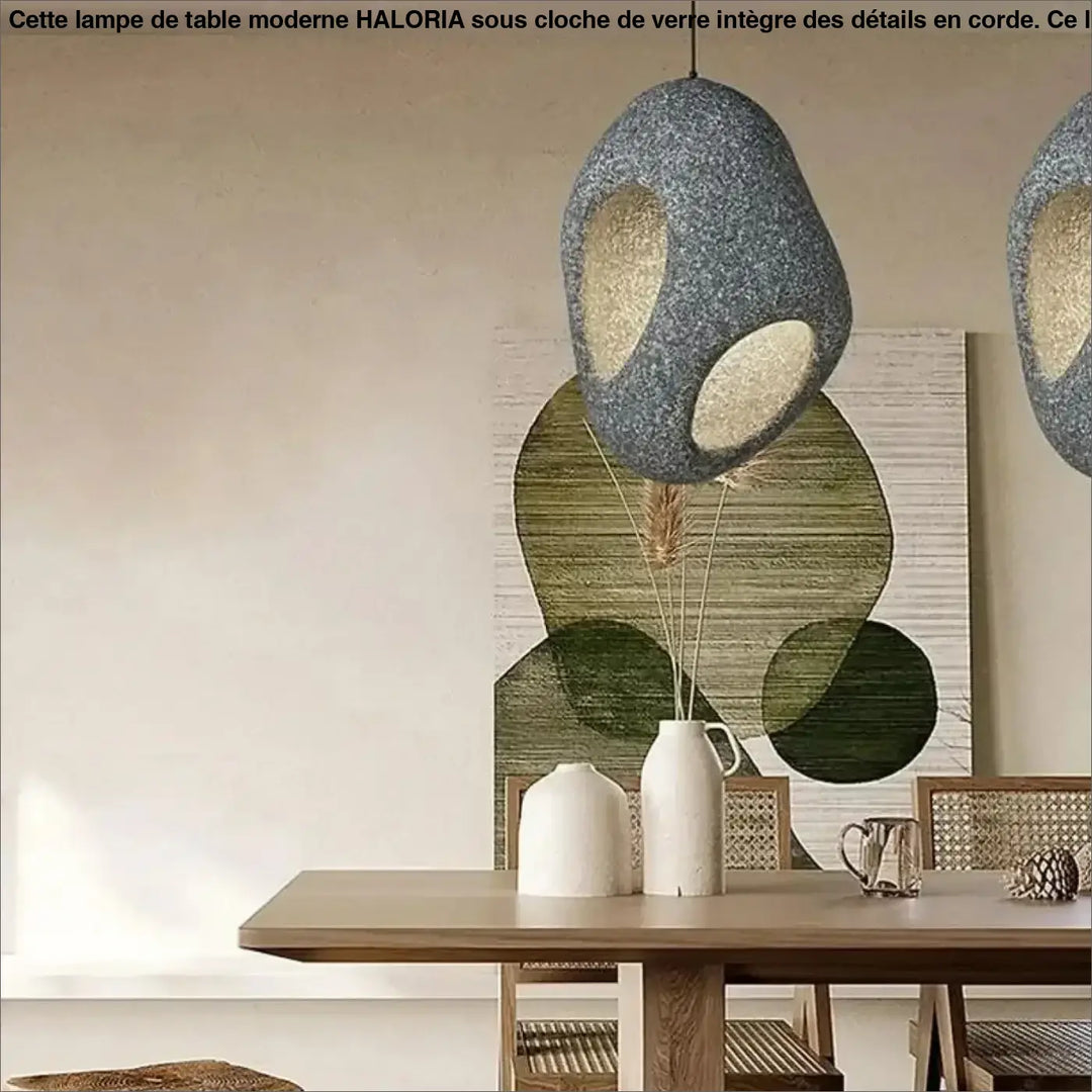 Suspension luminaire cavia gris texturé avec deux découpes ovales révélant une lueur intérieure chaude design aux