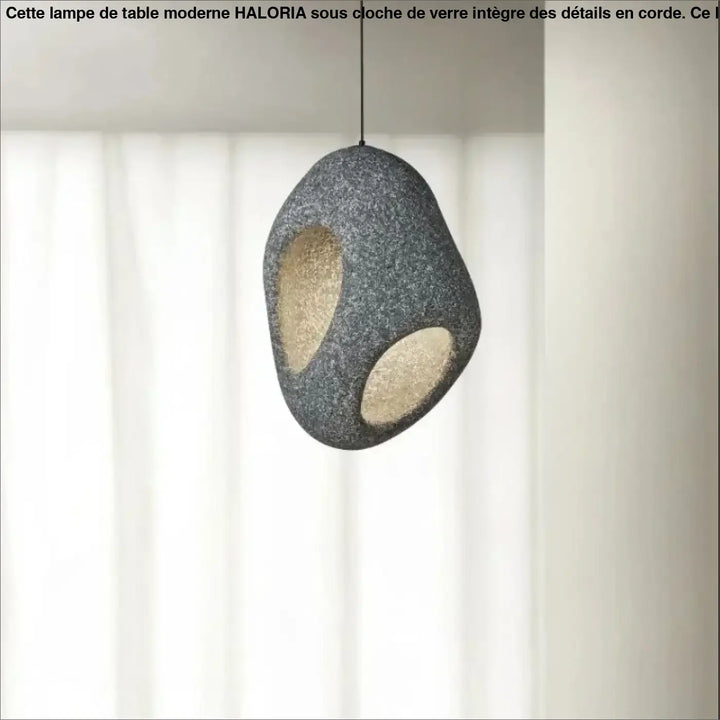 Suspension luminaire cavia gris texturé avec deux découpes ovales révélant une lueur intérieure chaleureuse en luminaire design aux