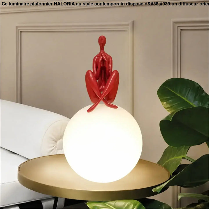 Lampe de table kelya avec silhouette enlacée rouge brillante sur base lumineuse sphérique pour un design moderne