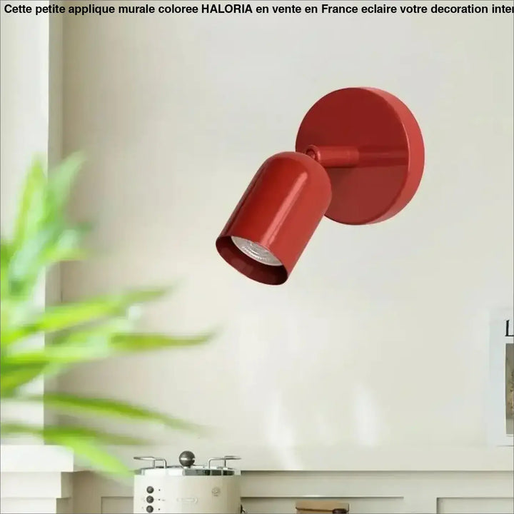 Petite applique murale coloree rouge metallique avec tete cylindrique et base circulaire modele haloria