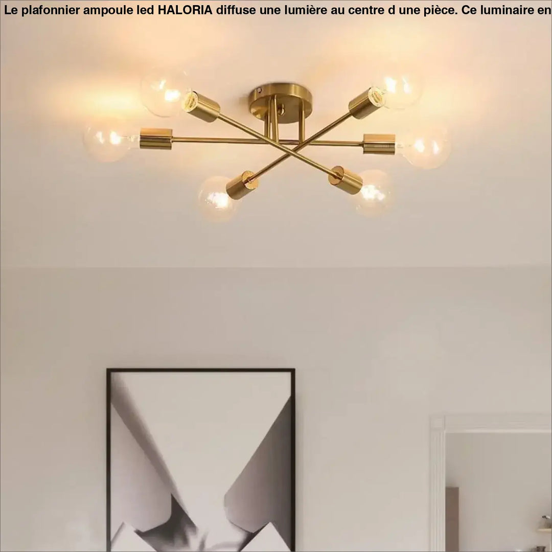 Plafonnier ampoule led haloria en finition laiton avec six douilles ampoule led disposées en croix symétrique