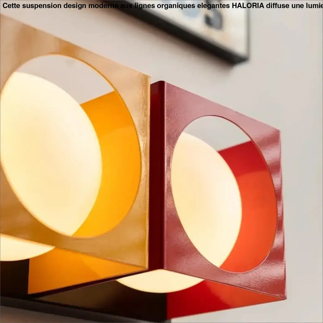 Applique murale suspension design moderne à lignes organiques elegantes en finition or brillant et rouge avec découpes circulaires lumineux