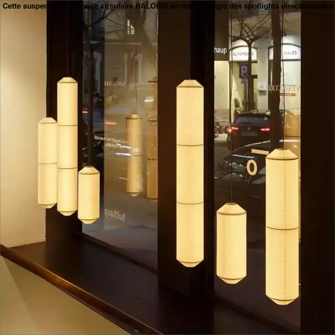 Suspension luminaire paperia avec lumière douce et cylindrique suspendue élégamment au-dessus d’une table en papier