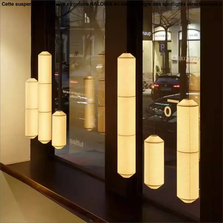 Suspension luminaire paperia avec lumière douce et cylindrique suspendue élégamment au-dessus d’une table en papier