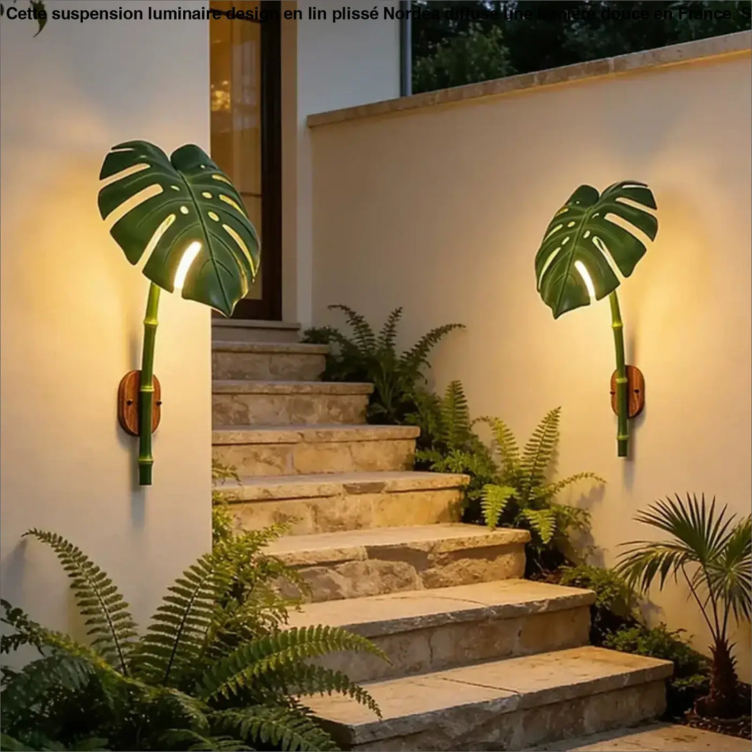 Luminaire extérieur leavah wall lamp green monstera leaf shape with bamboo stem accents and warm wooden backplates