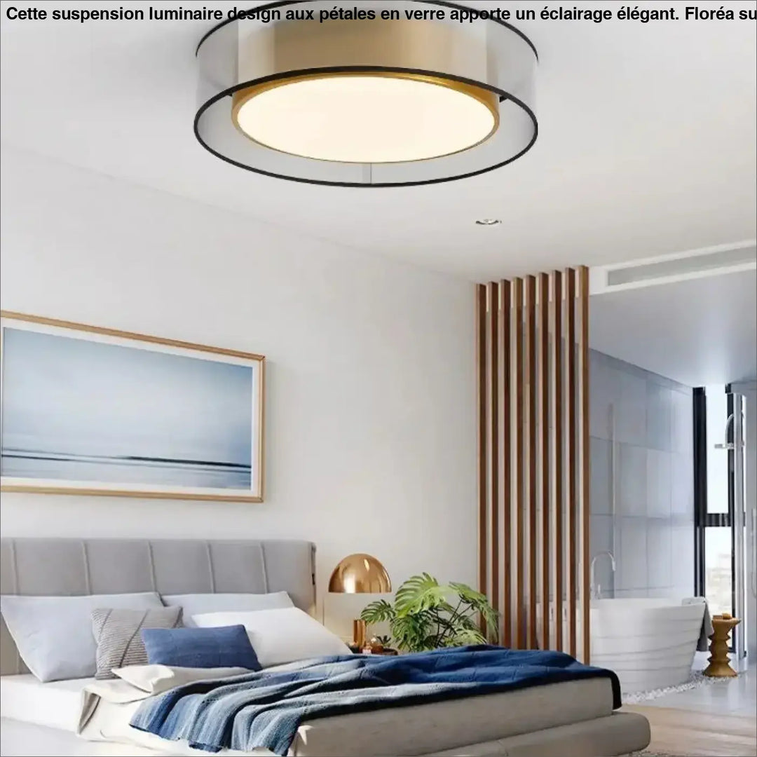 Luminaire plafonnier vadim moderne avec anneaux concentriques en métal noir et or brossé émettant une lueur chaude