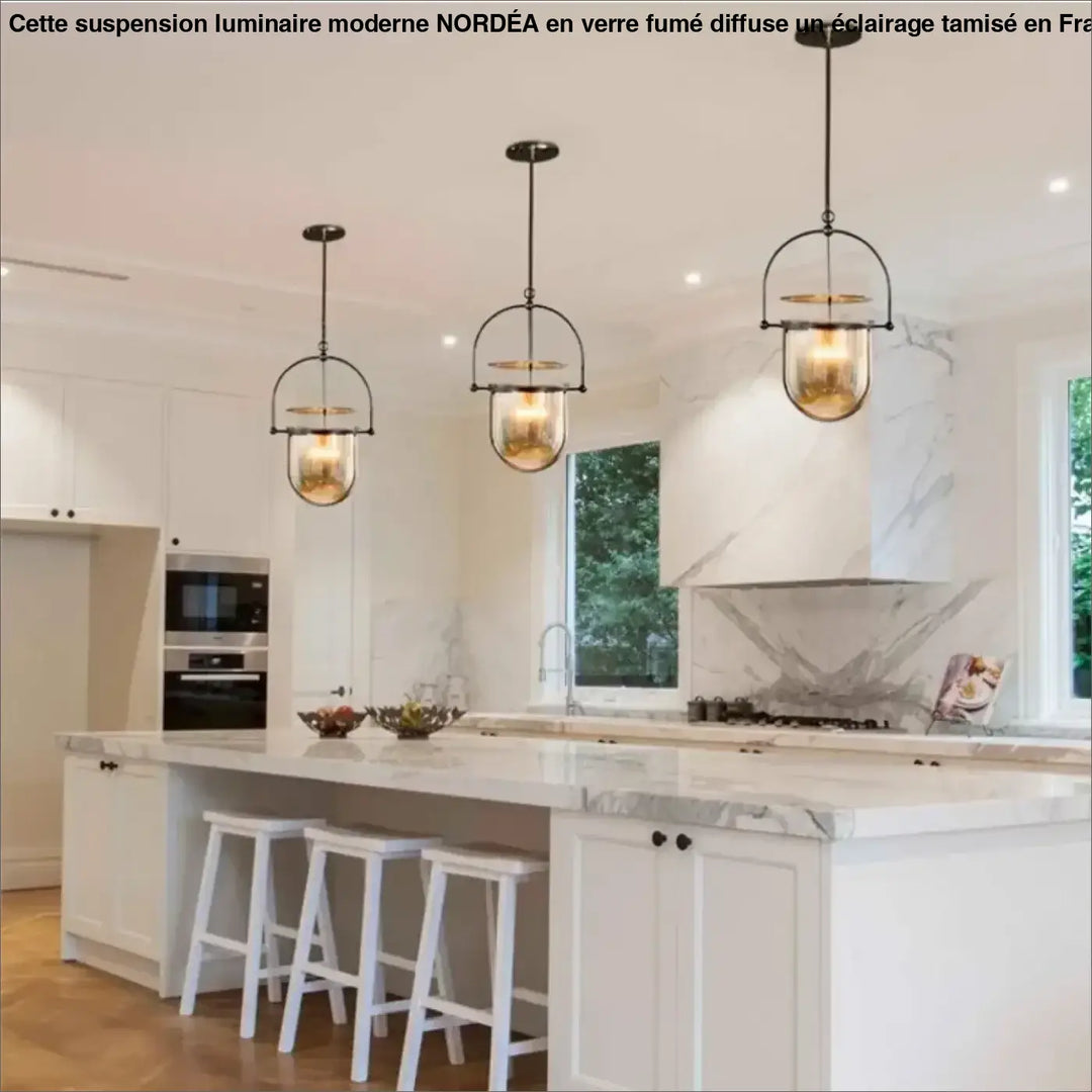 Trois suspensions lumineuses elysia en métal noir et ambre avec ampoules led au dessus dîlot en marbre blanc