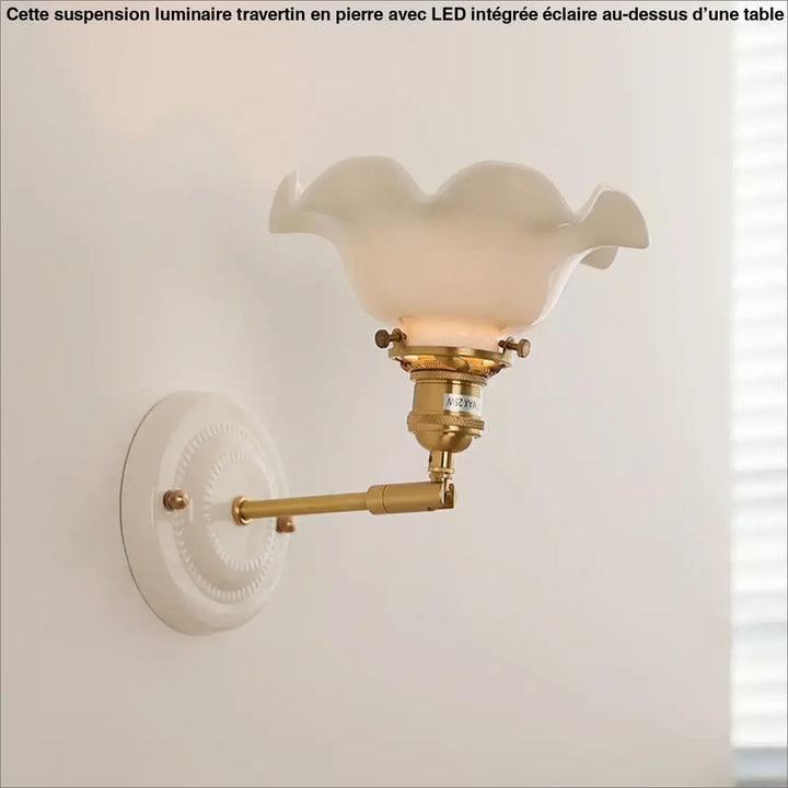 Luminaire travertin au-dessus d’une table avec une applique murale vintage en laiton et abat-jour en verre scallopé écru